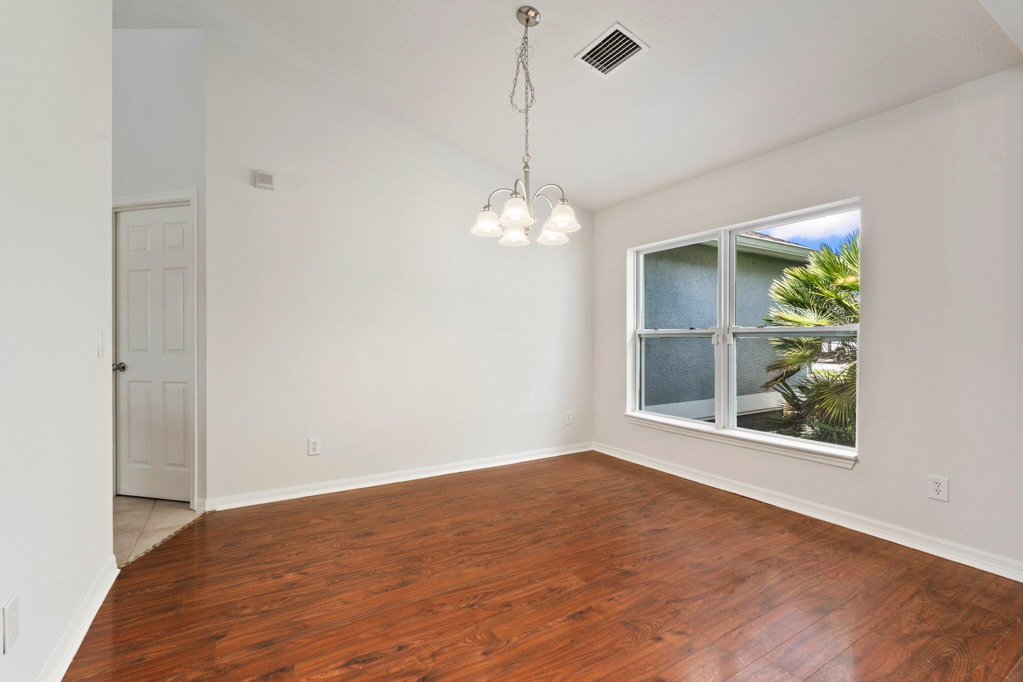 1901 Southwest Diamond Street Port St. Lucie, FL 34953 - Photo 6 of 42 a view of a room with wooden floor and entryway