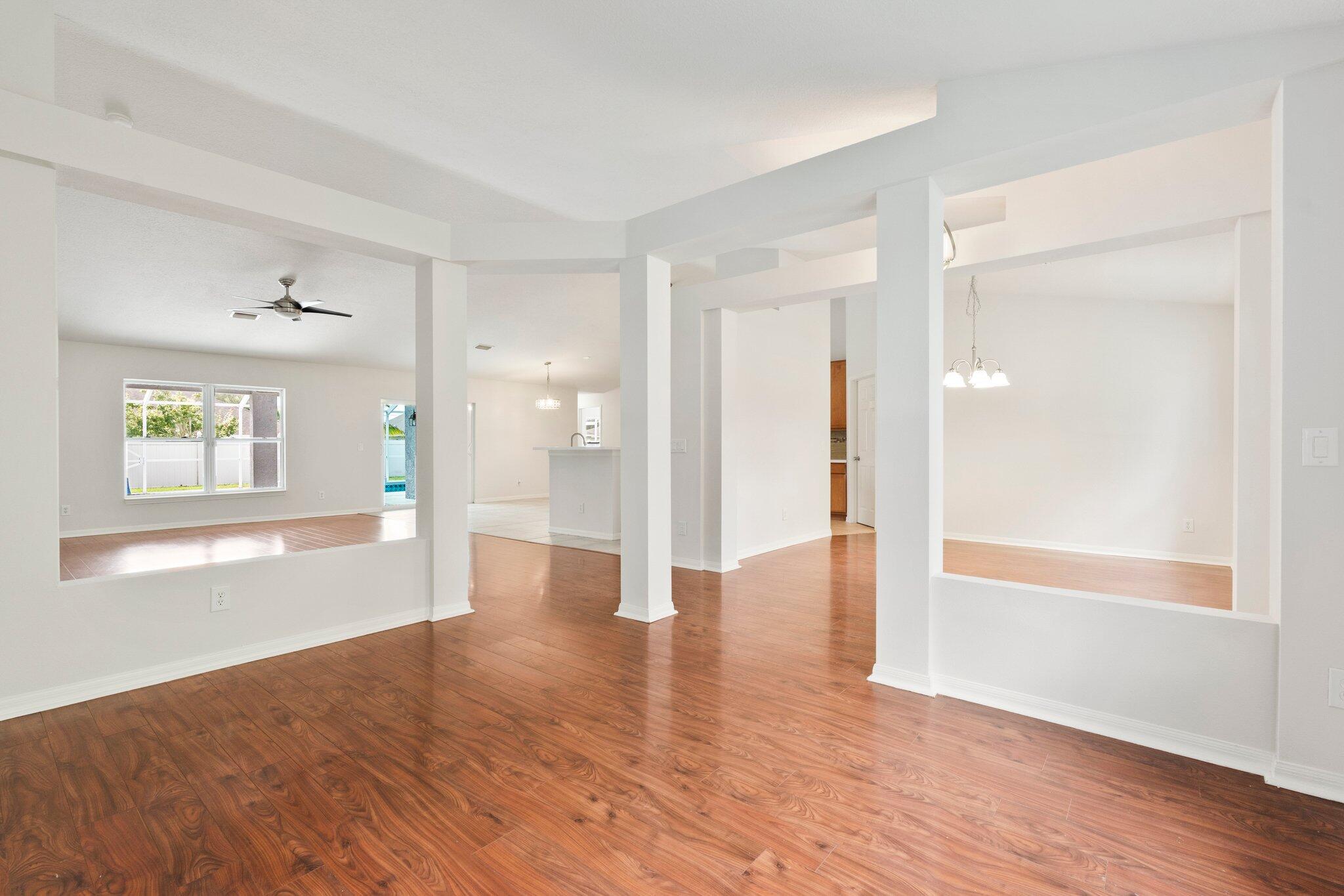 1901 Southwest Diamond Street Port St. Lucie, FL 34953 - Photo 7 of 42 a view of an empty room with window and wooden floor