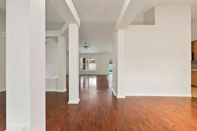 a view of a hallway with wooden floor