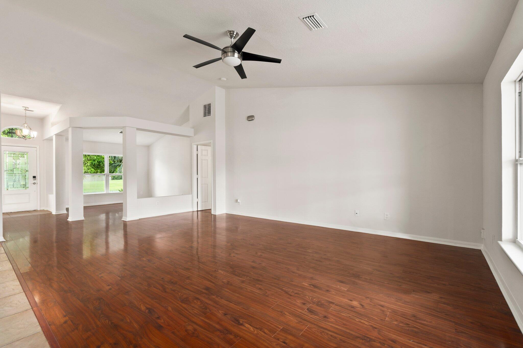 1901 Southwest Diamond Street Port St. Lucie, FL 34953 - Photo 10 of 42 a view of empty room with wooden floor and window