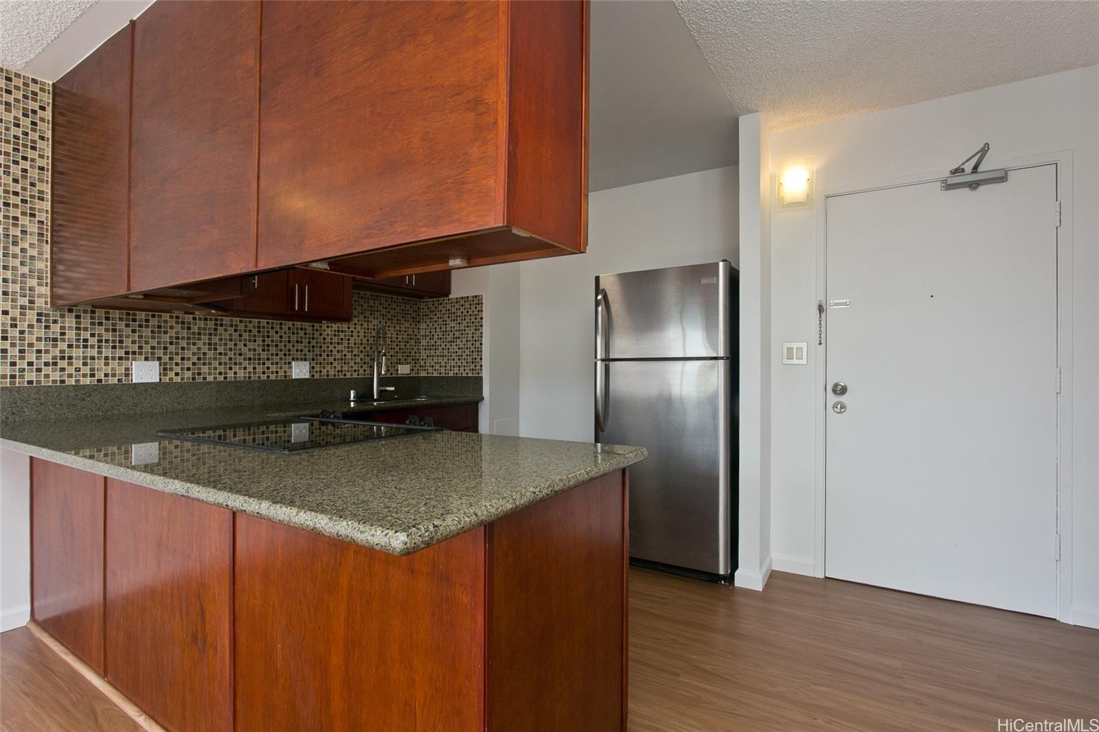 3045 Ala Napuaa Place, Unit 306 Honolulu, HI 96818 - Photo 5 of 15 a kitchen with stainless steel appliances granite countertop a refrigerator a sink and a stove
