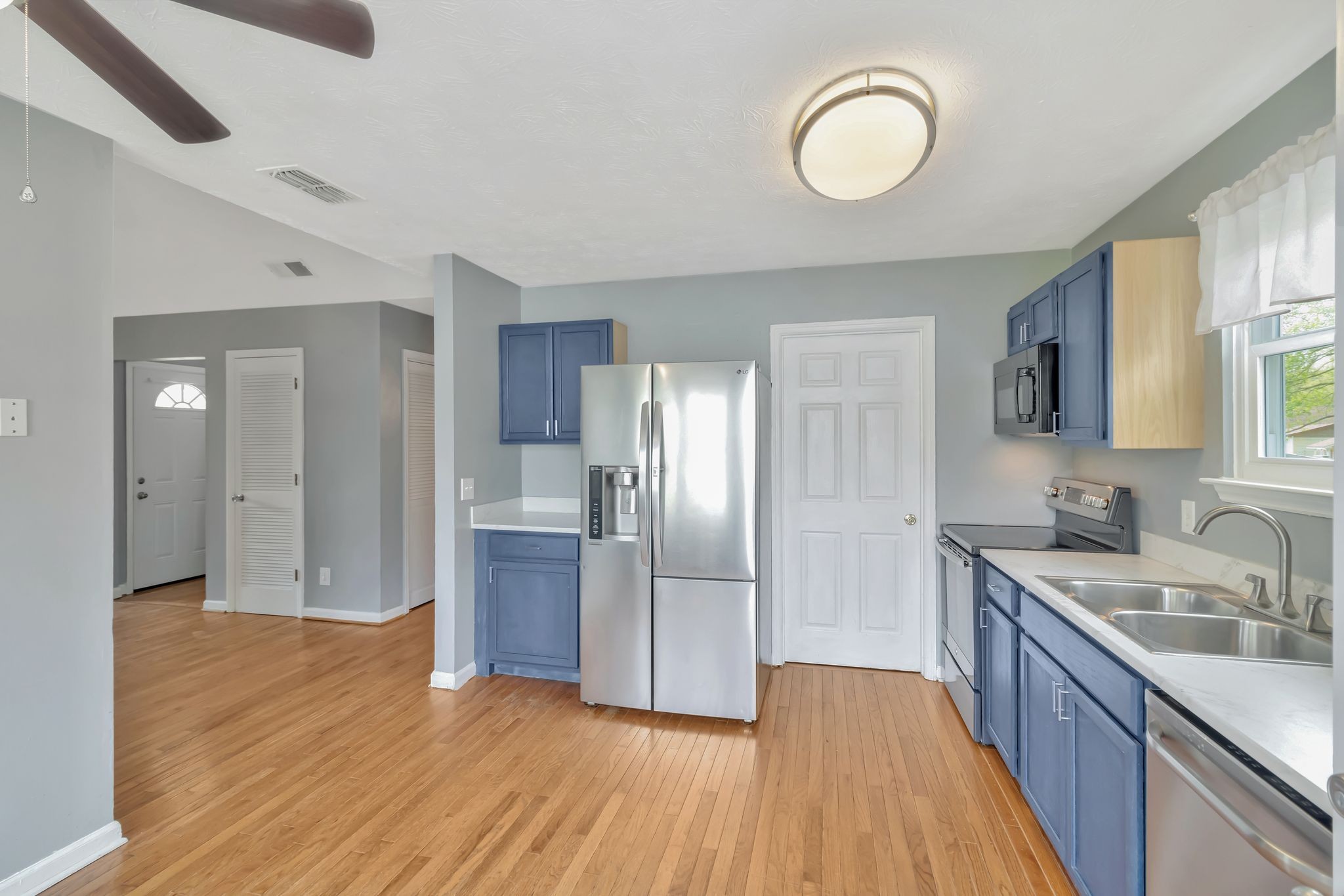 7543 Chadwick Drive Murfreesboro, TN 37129 - Photo 9 of 16 a kitchen with a sink and wooden floor