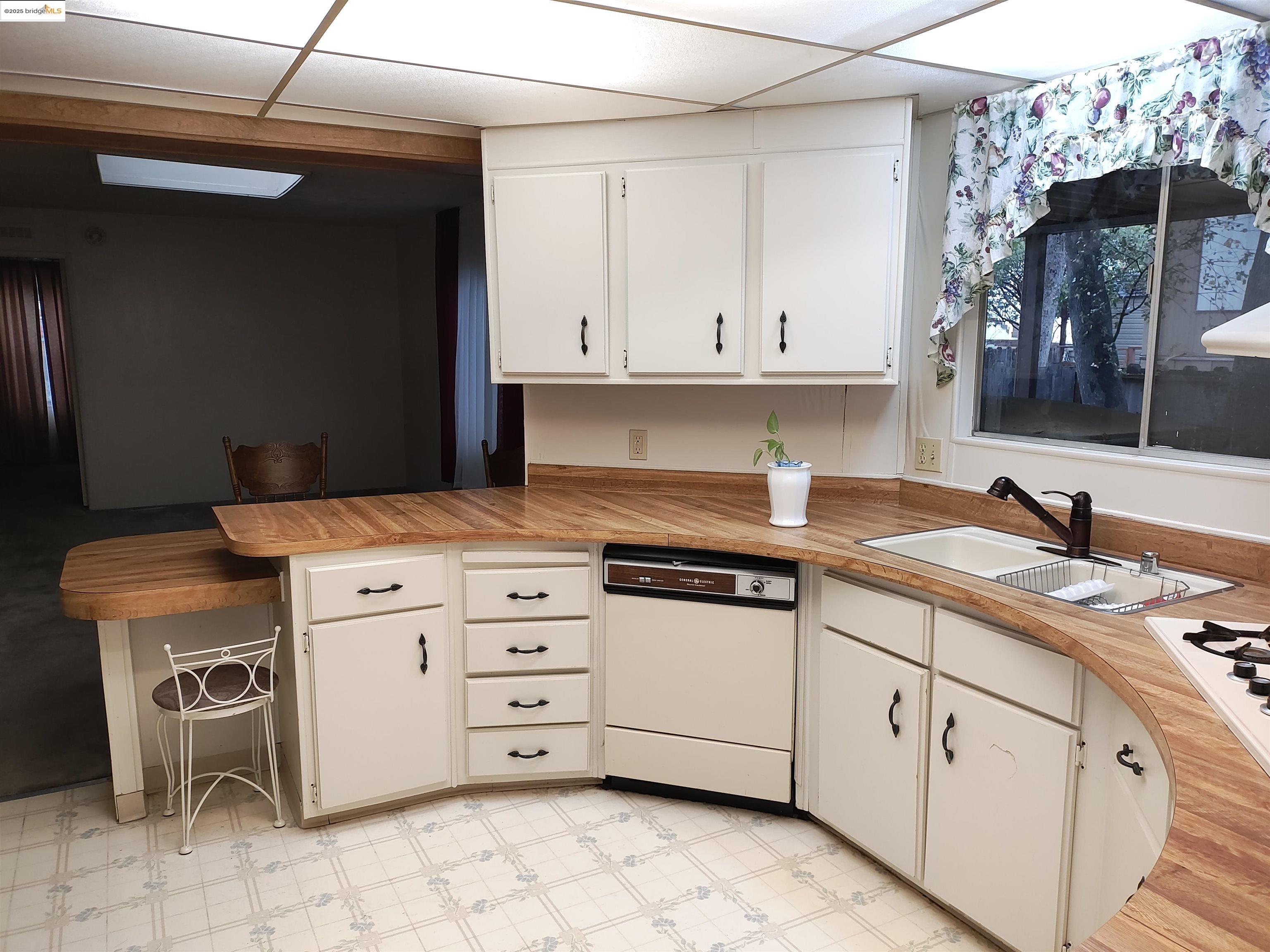 10956 Green Street, Unit 152 Columbia, CA 95310 - Photo 13 of 46 a kitchen with cabinets appliances and a sink