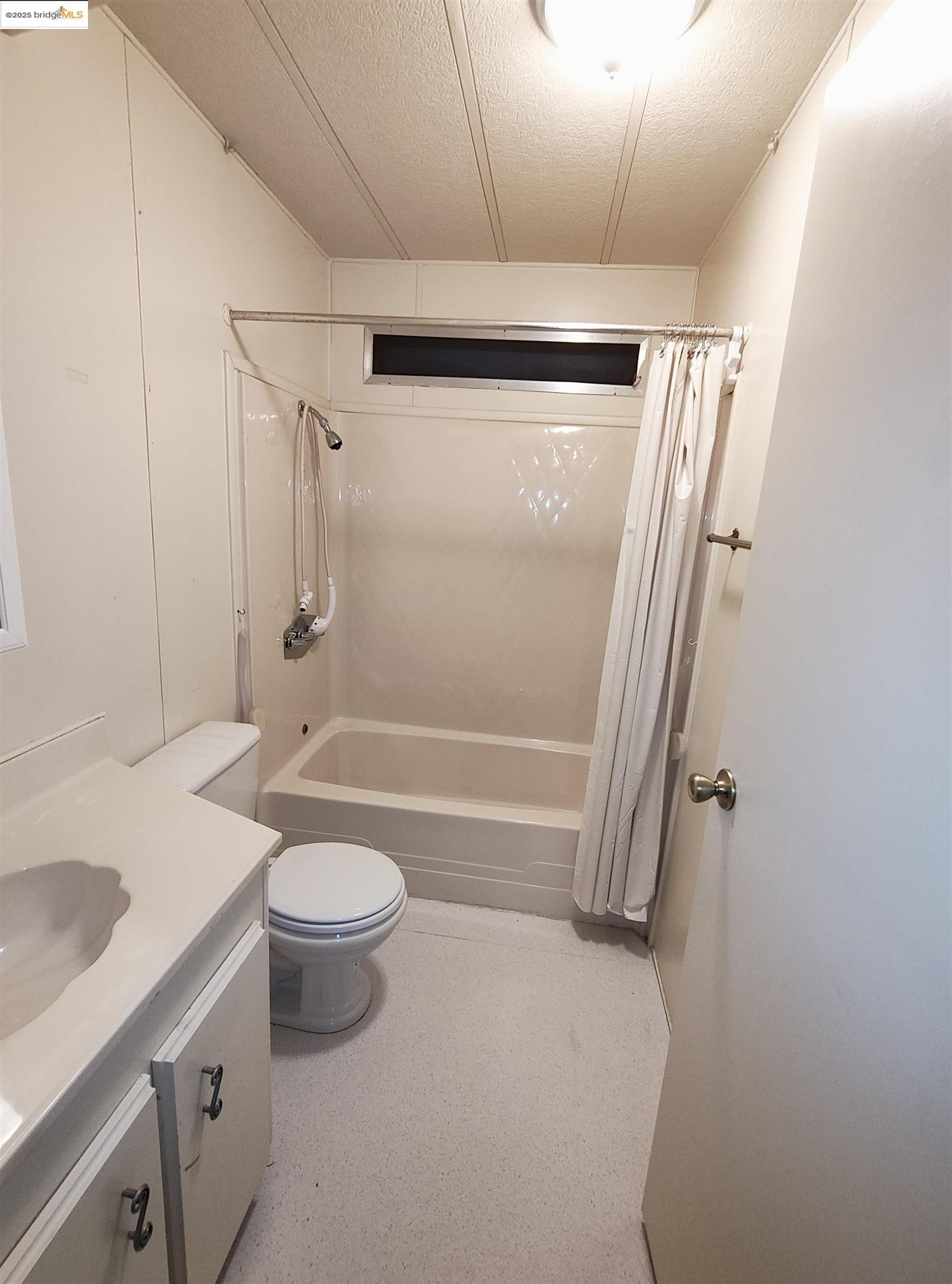 10956 Green Street, Unit 152 Columbia, CA 95310 - Photo 21 of 46 a bathroom with a granite countertop sink toilet and shower
