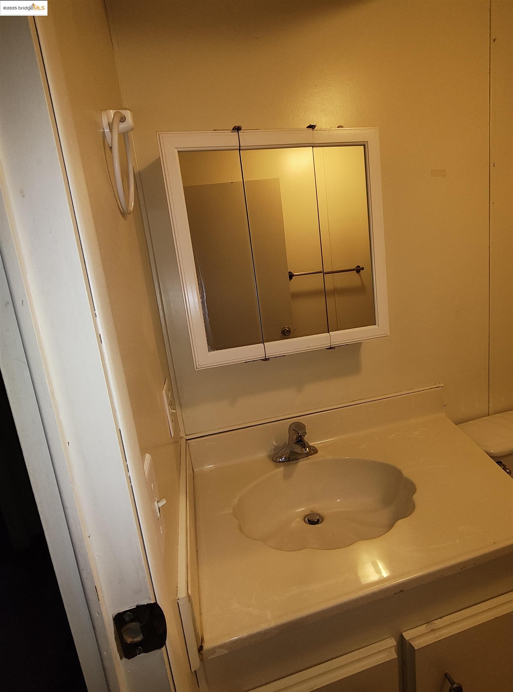 10956 Green Street, Unit 152 Columbia, CA 95310 - Photo 22 of 46 a bathroom with a sink and mirror