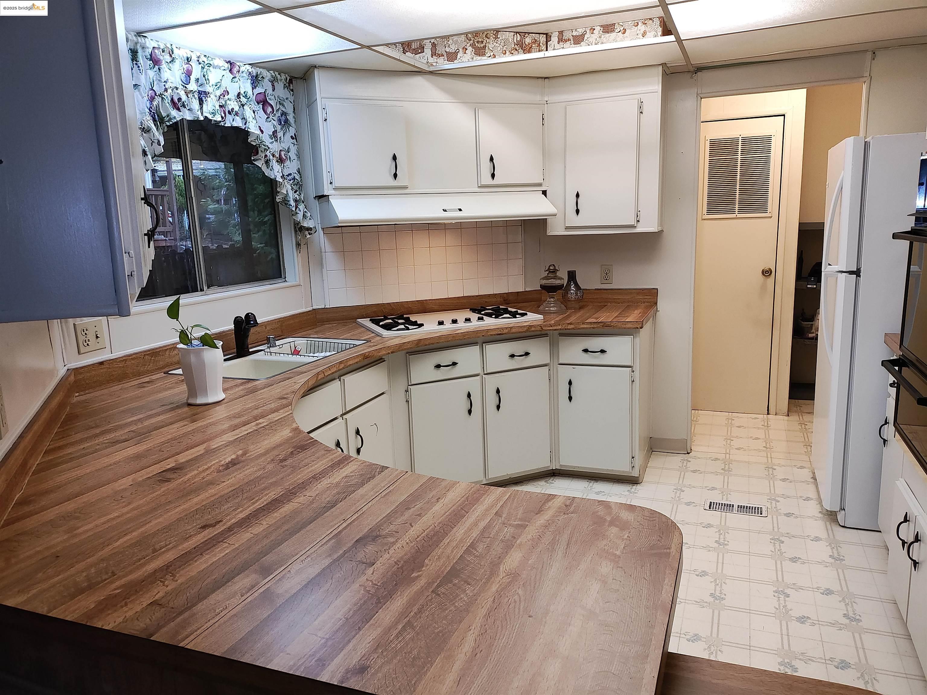 10956 Green Street, Unit 152 Columbia, CA 95310 - Photo 32 of 46 a kitchen with stainless steel appliances granite countertop a sink stove and refrigerator