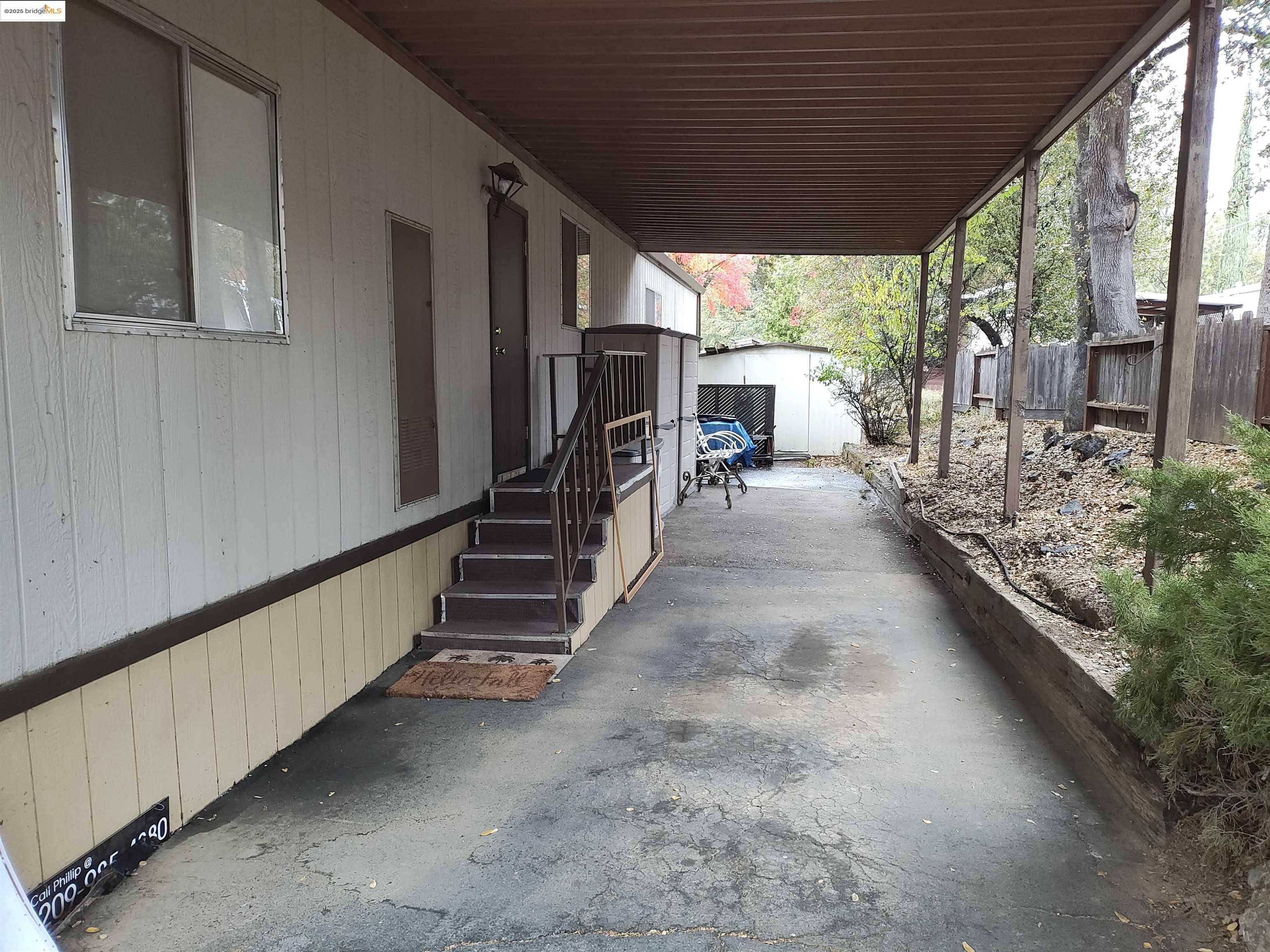 10956 Green Street, Unit 152 Columbia, CA 95310 - Photo 6 of 46 a hallway with stairs and a yard