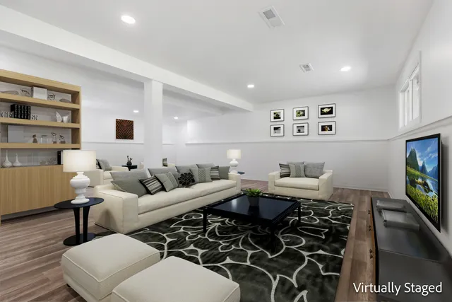 a living room with furniture a rug and a flat screen tv