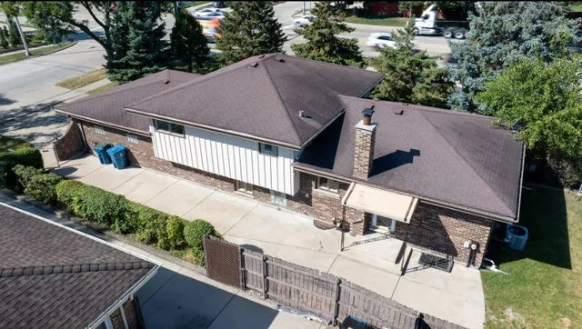 an aerial view of a house with a yard
