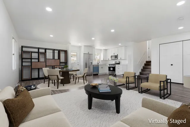 a living room with furniture and a dining table with wooden floor