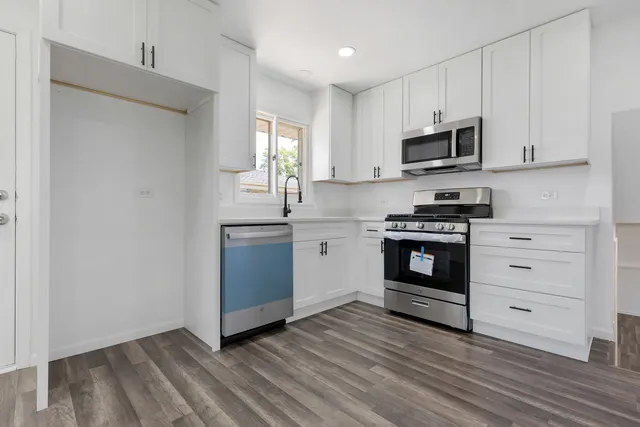 a kitchen with stainless steel appliances a stove and a microwave