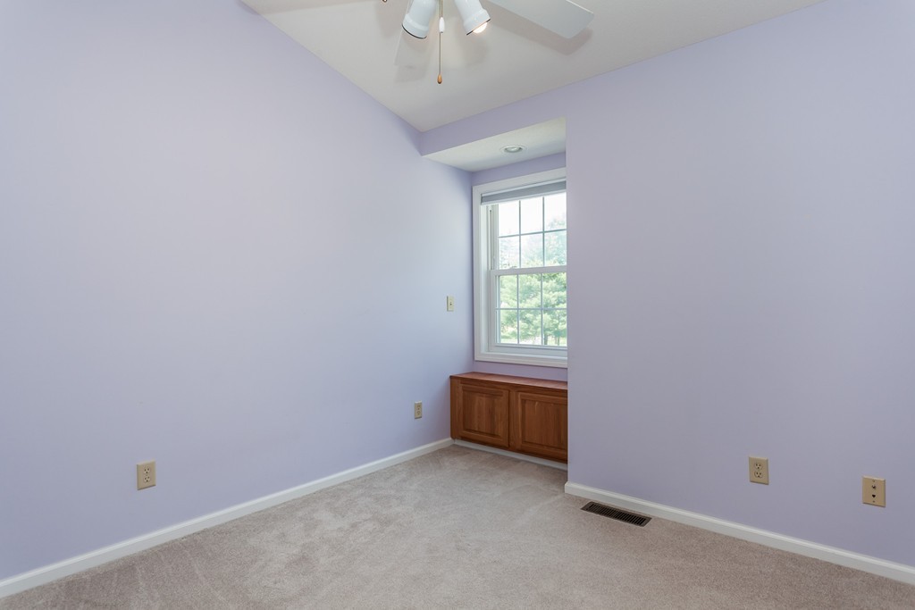 30 Two Ponds Road Belchertown, MA 01007 - Photo 17 of 26 an empty room with a chandelier fan and windows