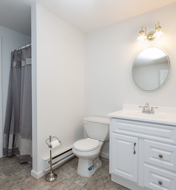 30 Two Ponds Road Belchertown, MA 01007 - Photo 21 of 26 a bathroom with a toilet a sink and mirror
