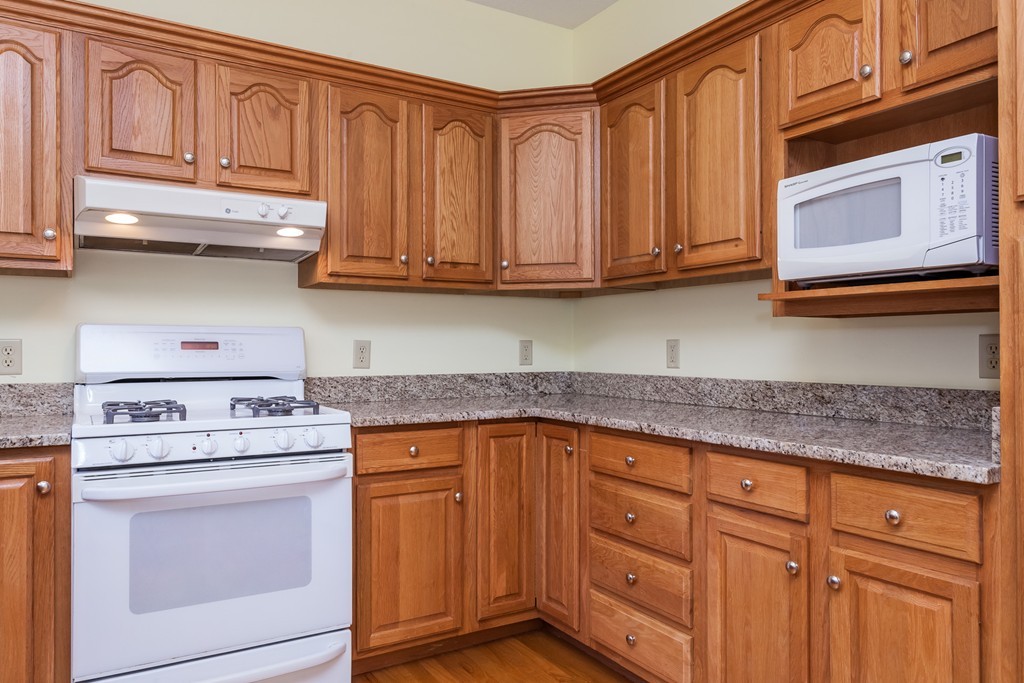 30 Two Ponds Road Belchertown, MA 01007 - Photo 5 of 26 a kitchen with stainless steel appliances granite countertop a stove microwave and cabinets