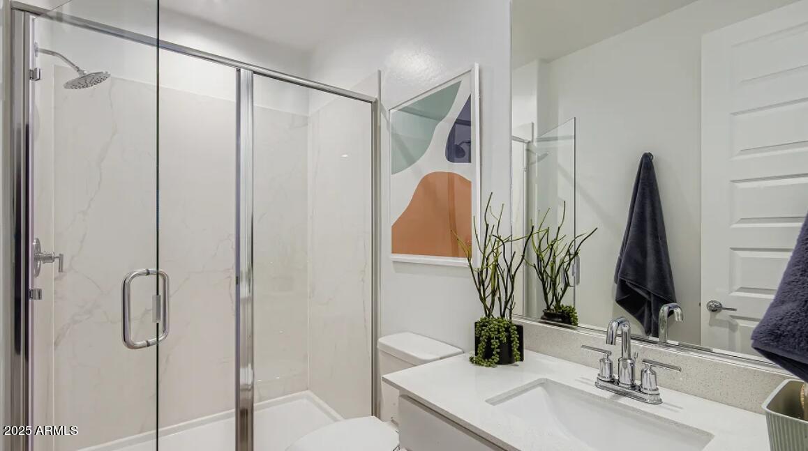 9540 West Flower Street Phoenix, AZ 85392 - Photo 13 of 22 a bathroom with a double vanity sink and a mirror