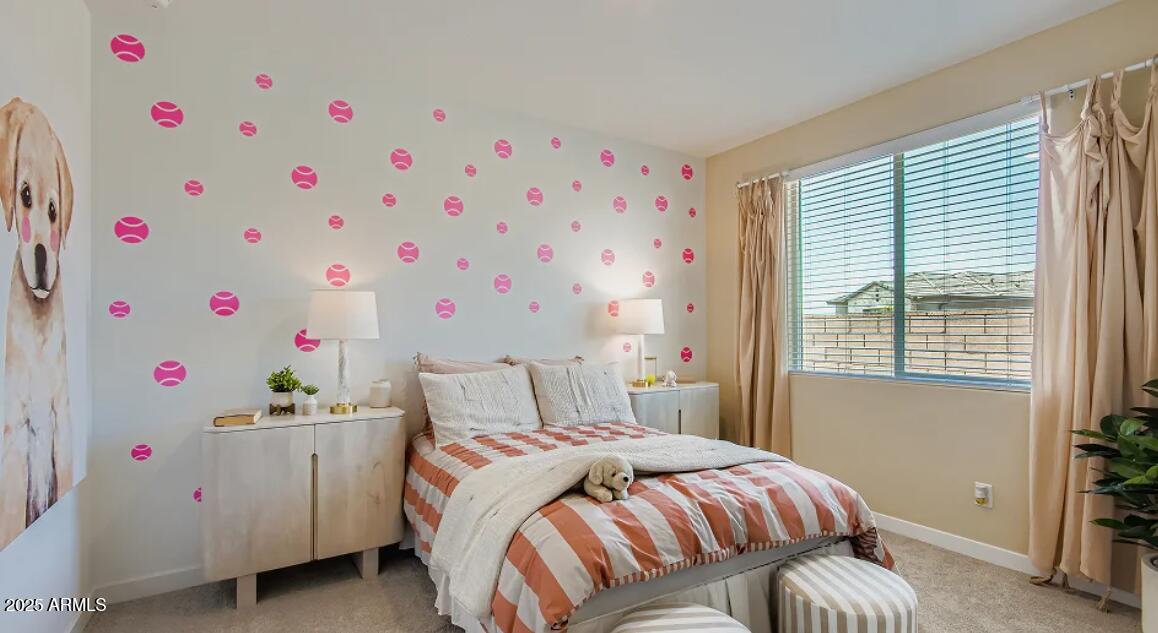 9540 West Flower Street Phoenix, AZ 85392 - Photo 15 of 22 a bedroom with a bed and a window