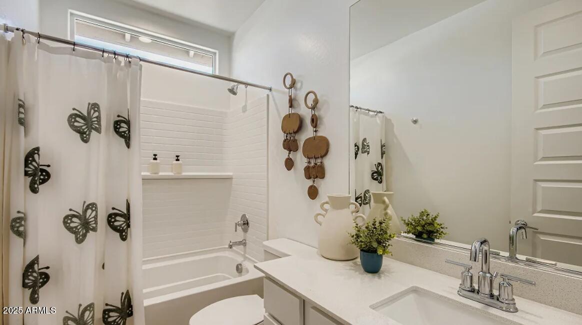 9540 West Flower Street Phoenix, AZ 85392 - Photo 16 of 22 a bathroom with a shower curtain and a sink