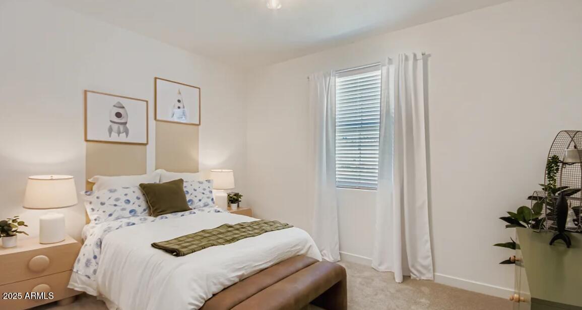 9540 West Flower Street Phoenix, AZ 85392 - Photo 17 of 22 a bedroom with a bed and a potted plant