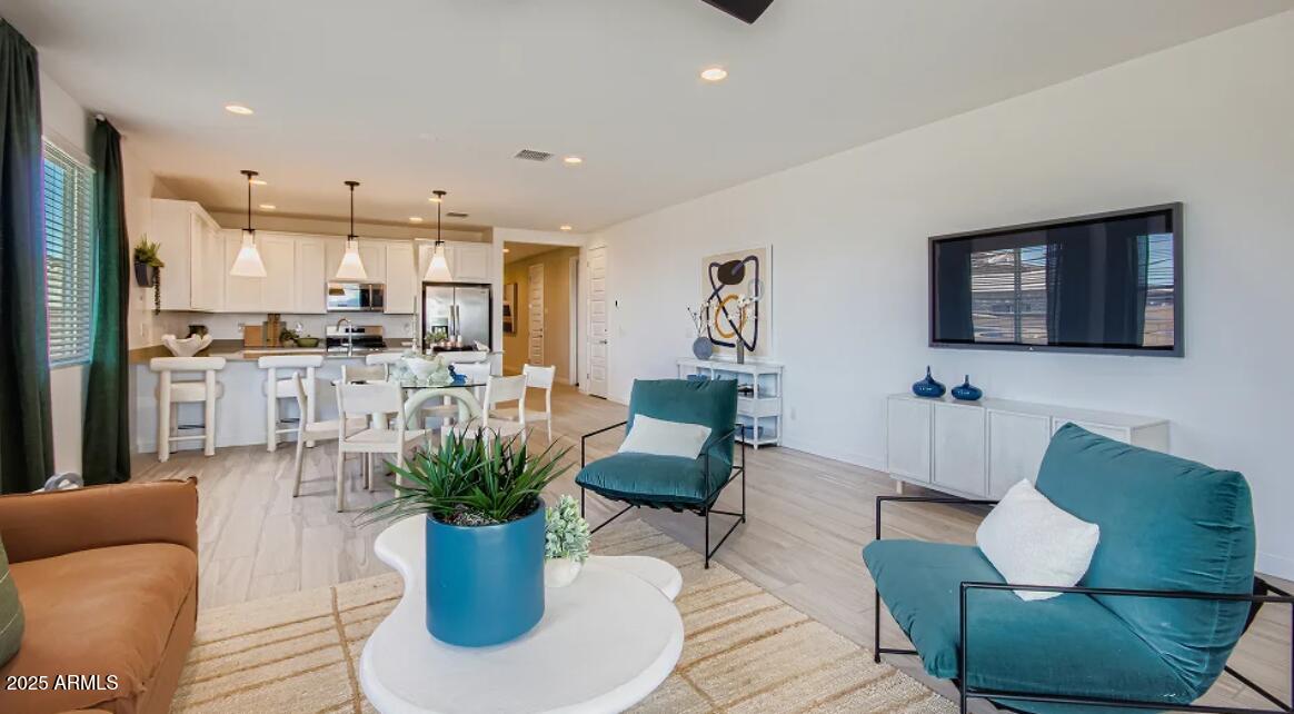 9540 West Flower Street Phoenix, AZ 85392 - Photo 5 of 22 a living room with furniture potted plant and kitchen view