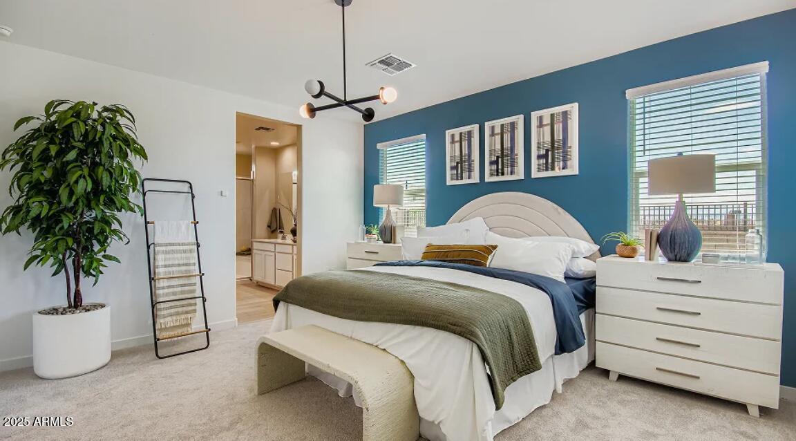 9540 West Flower Street Phoenix, AZ 85392 - Photo 8 of 22 a bedroom with a large bed and a potted plant