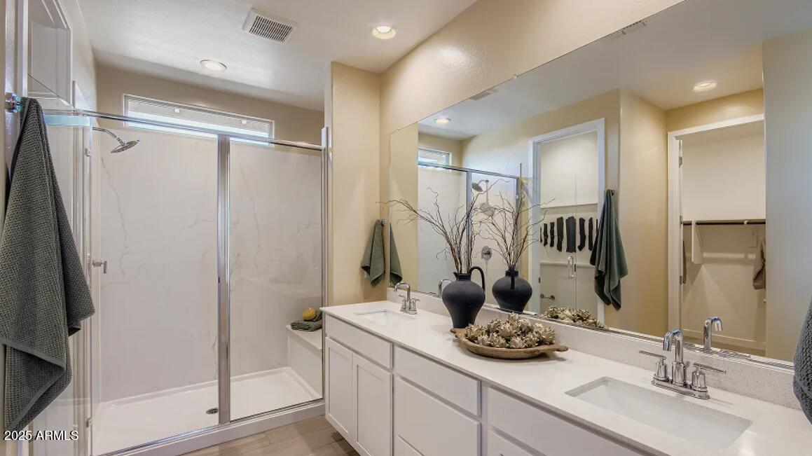 9540 West Flower Street Phoenix, AZ 85392 - Photo 9 of 22 a bathroom with a granite countertop sink and a mirror