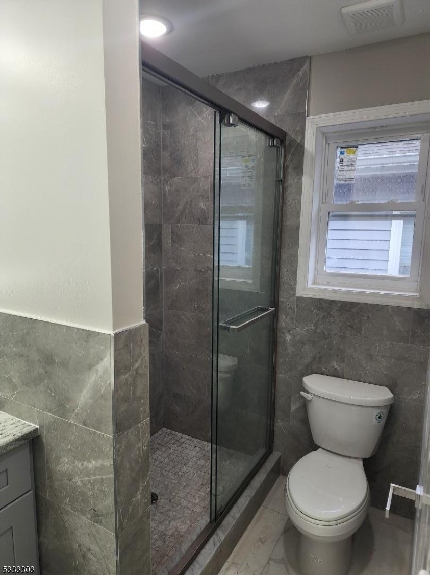 20 Garibaldi Avenue Newark, NJ 07114 - Photo 2 of 12 a bathroom with a toilet and a shower