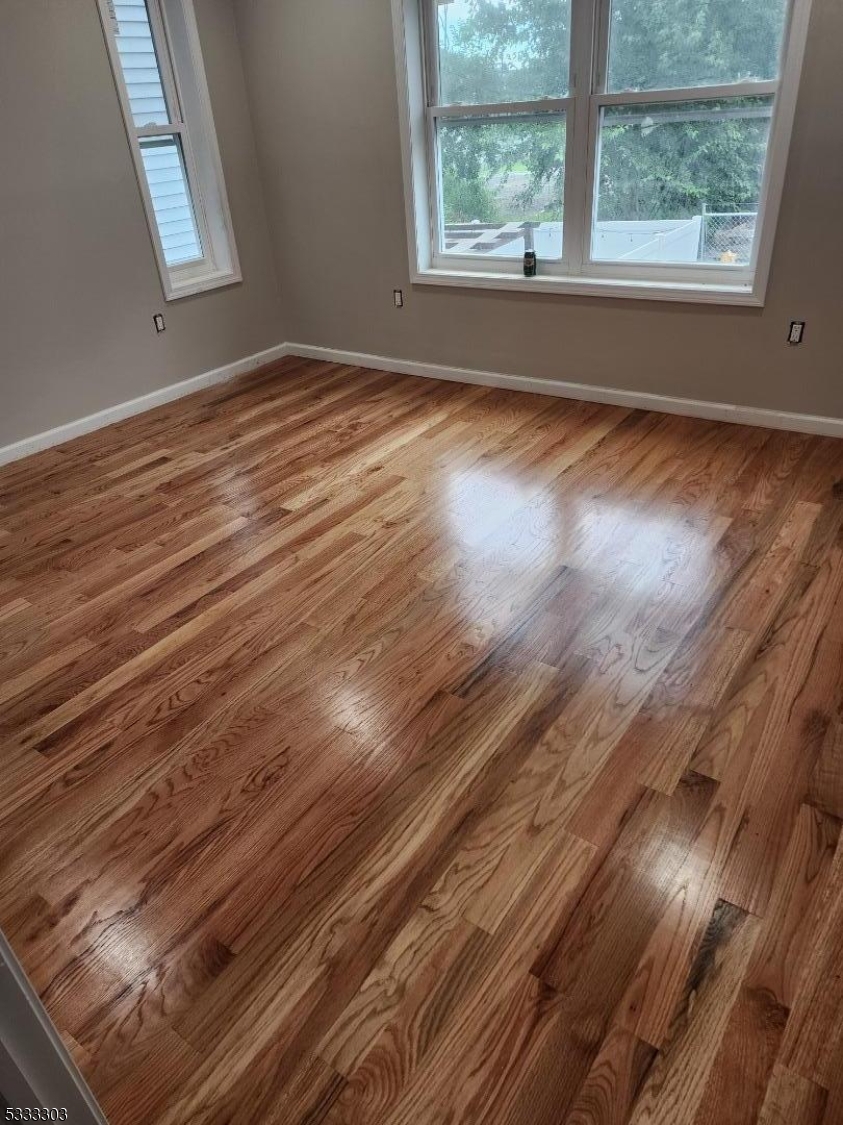 20 Garibaldi Avenue Newark, NJ 07114 - Photo 7 of 12 a view of empty room with wooden floor and fan