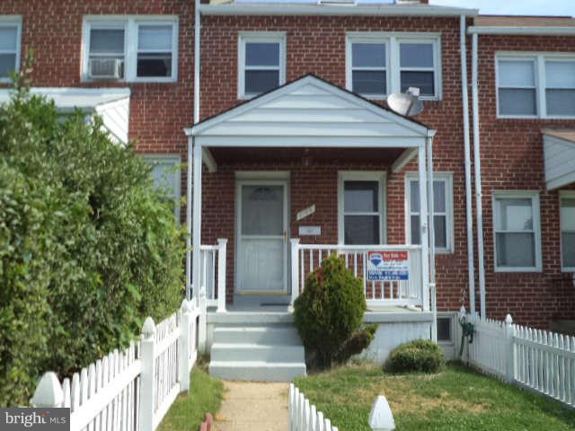 1132 Elm Road Baltimore, MD 21227 - Photo 2 of 27 front view of a house with a yard