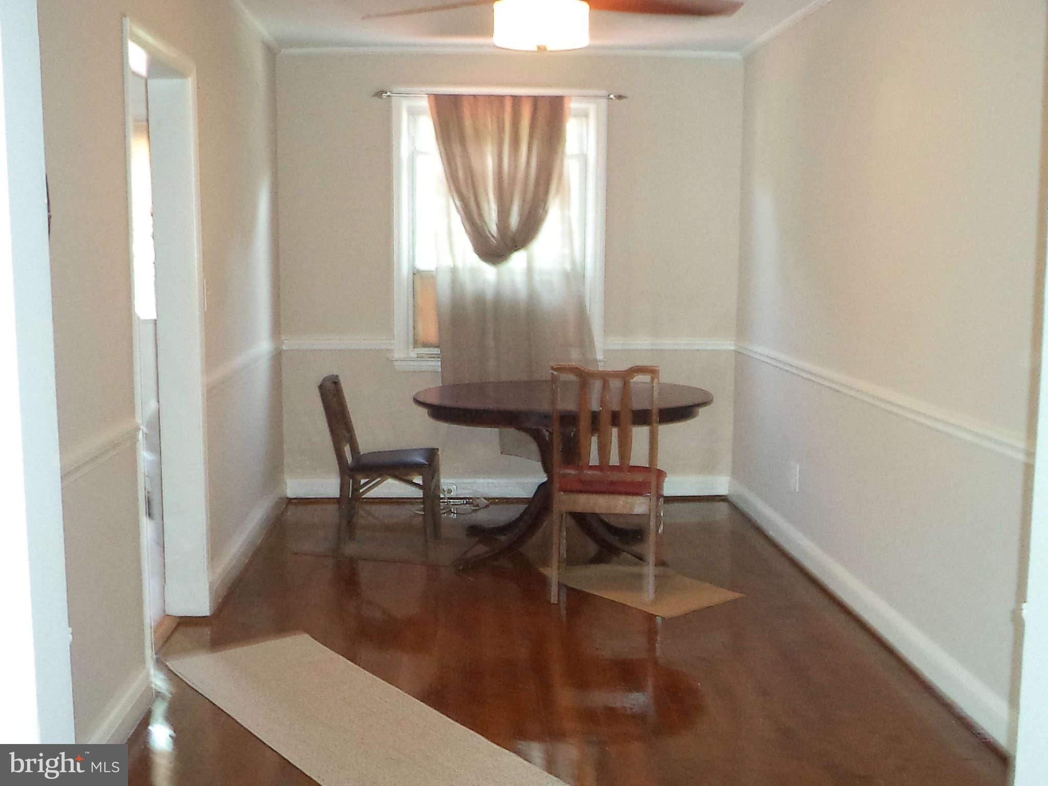1132 Elm Road Baltimore, MD 21227 - Photo 11 of 27 a dining room with furniture and wooden floor