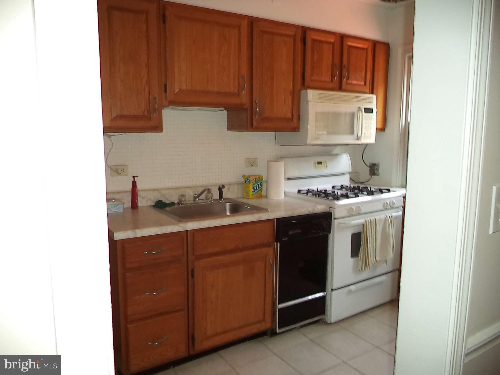 1132 Elm Road Baltimore, MD 21227 - Photo 12 of 27 a kitchen with stainless steel appliances granite countertop a sink stove and cabinets
