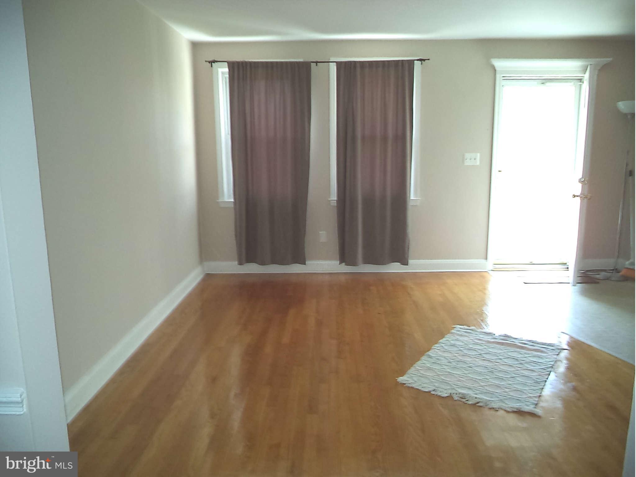 1132 Elm Road Baltimore, MD 21227 - Photo 17 of 27 a view of wooden floor and windows in a room