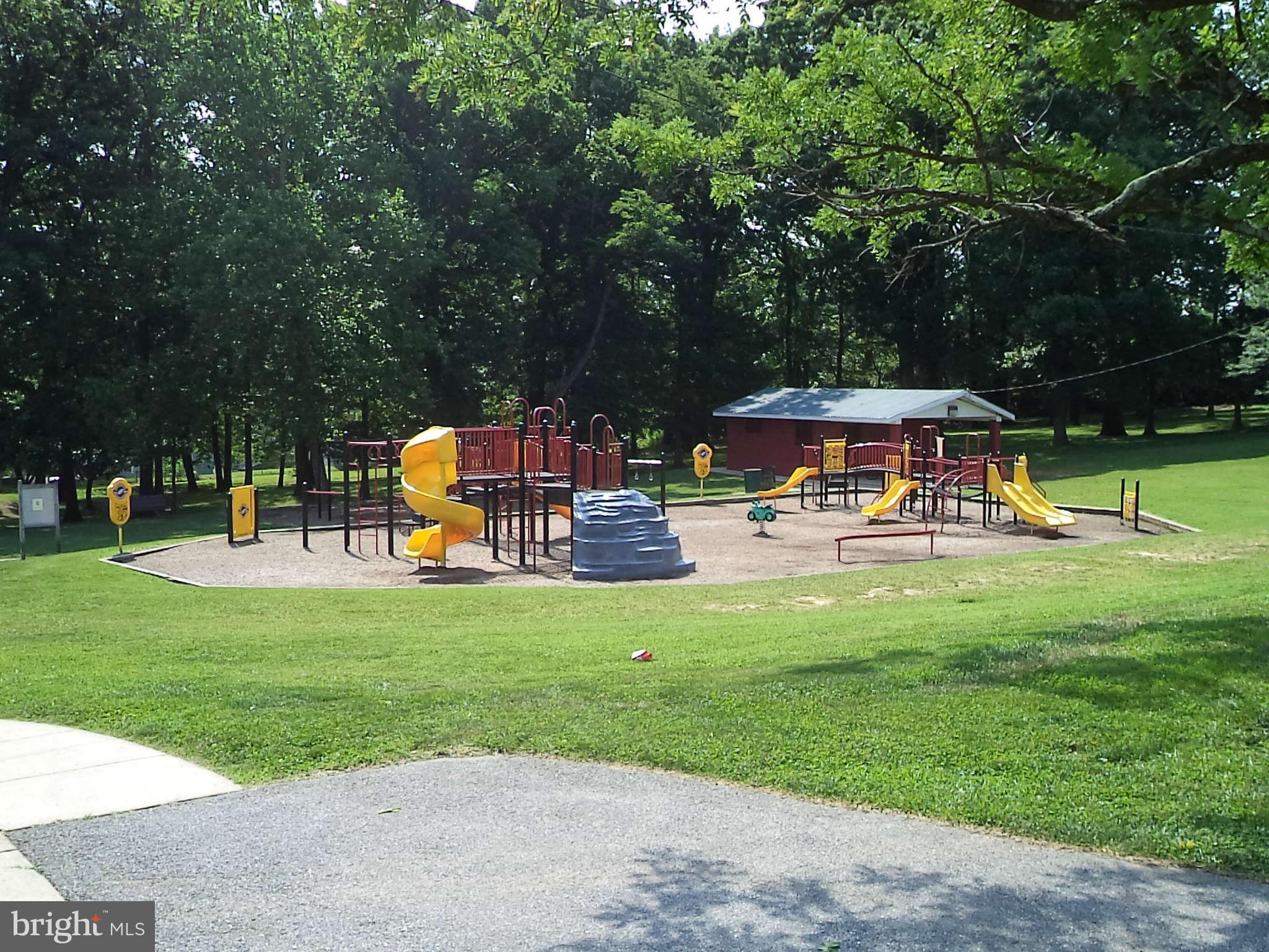 1132 Elm Road Baltimore, MD 21227 - Photo 18 of 27 a view of a park with lawn chairs and a large tree
