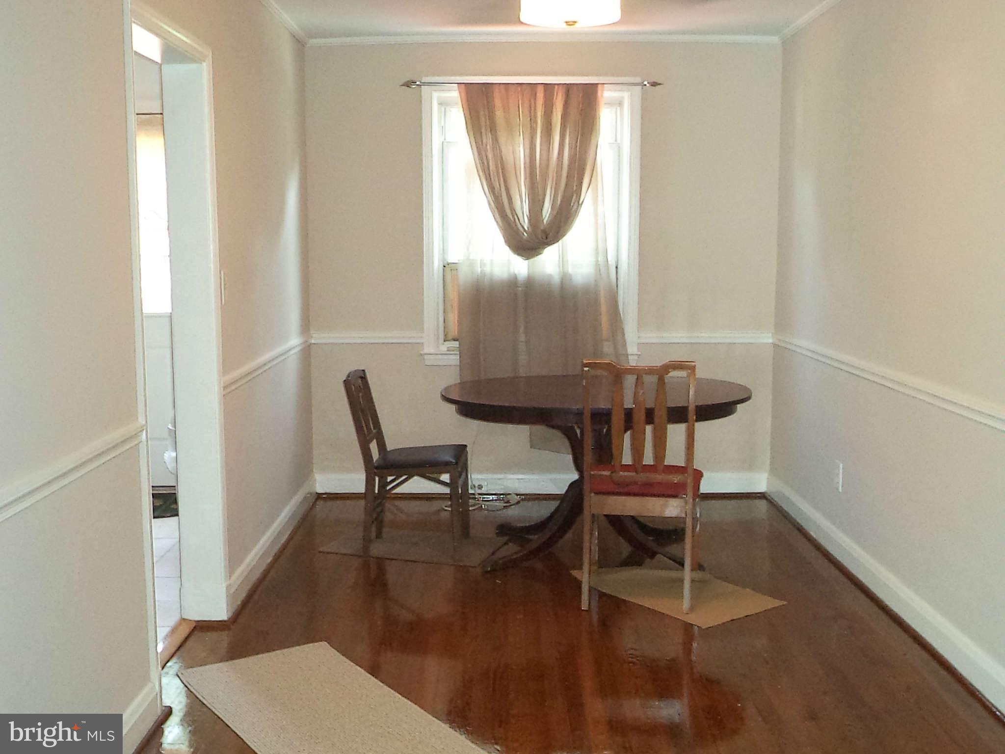 1132 Elm Road Baltimore, MD 21227 - Photo 10 of 27 a dining room with furniture and wooden floor