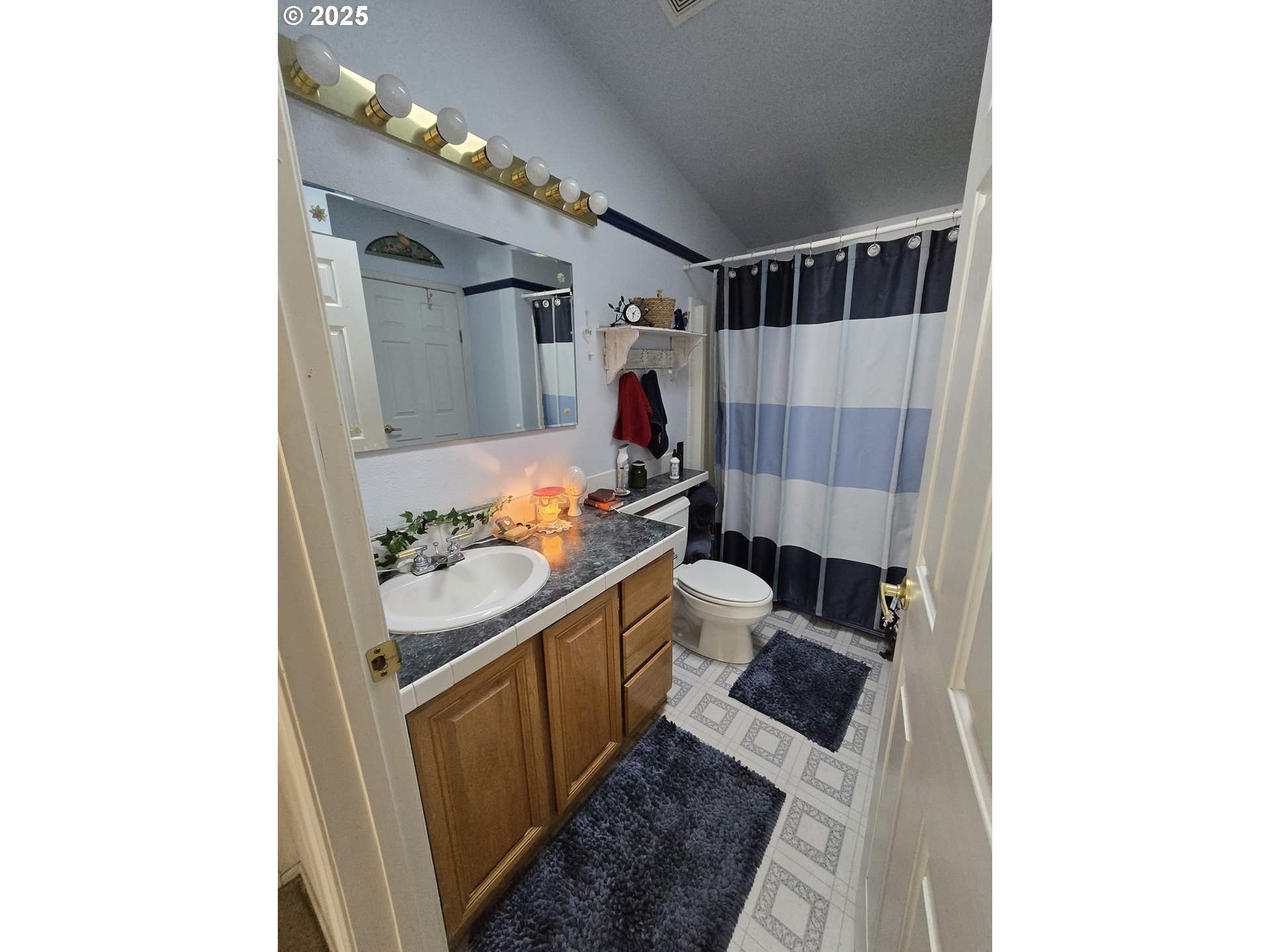 118 Fish Hatchery Lane Enterprise, OR 97828 - Photo 9 of 25 a bathroom with a sink and a shower curtain