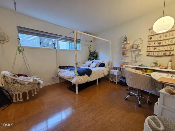 a bed room with a bed and a chair