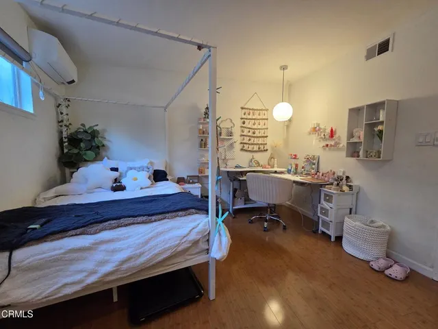 a bed room with a bed and a chair
