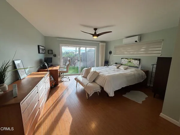 a bedroom with a bed and a large window