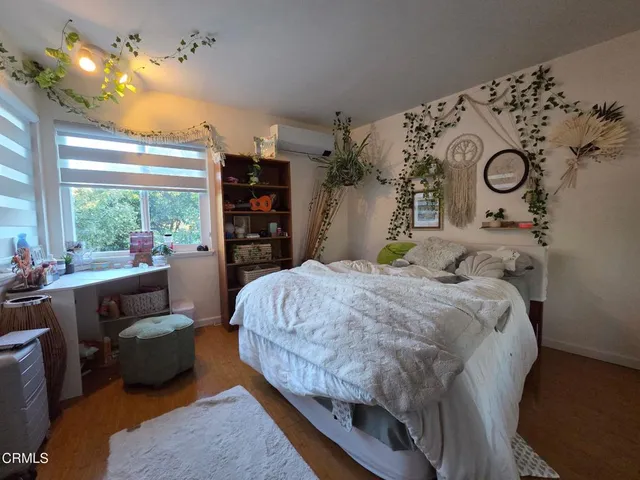 a bedroom with a large bed and a window