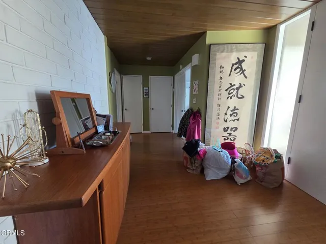 a bedroom with a bed furniture and a flat tv screen