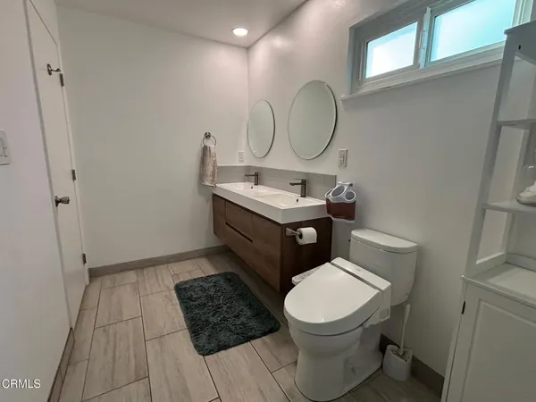 a bathroom with a sink and glass door