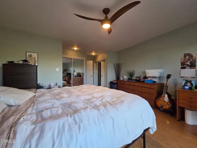 a bathroom with a toilet sink double vanity and mirror