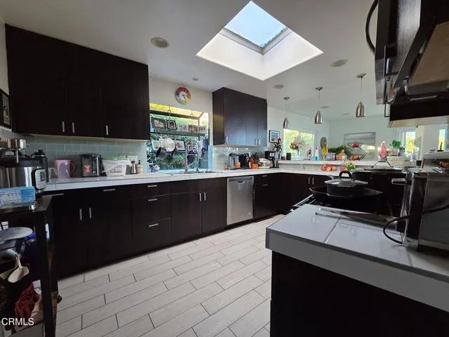 a kitchen with stainless steel appliances a sink stove and refrigerator