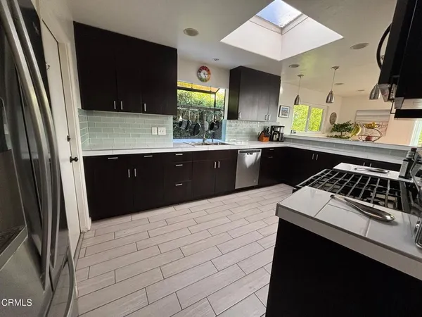 a kitchen with a sink a stove and cabinets