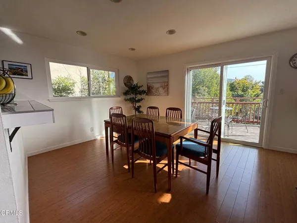 a dining room with furniture and a floor to ceiling window