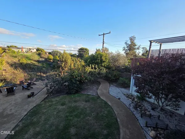 a backyard of a house with fountain swing and slide