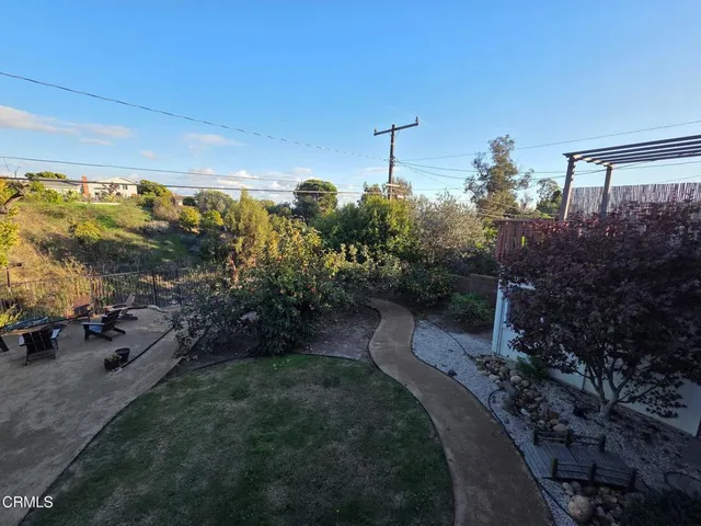 a backyard of a house with fountain swing and slide