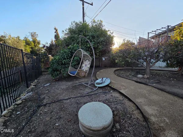a view of a porch with furniture and a yard