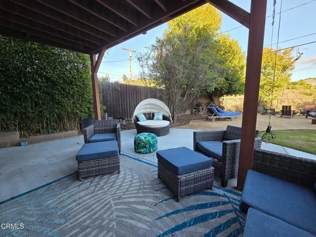 a outdoor living space with furniture and a fireplace