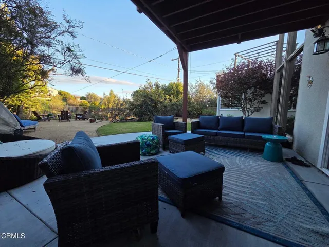 a view of backyard with outdoor seating and plants