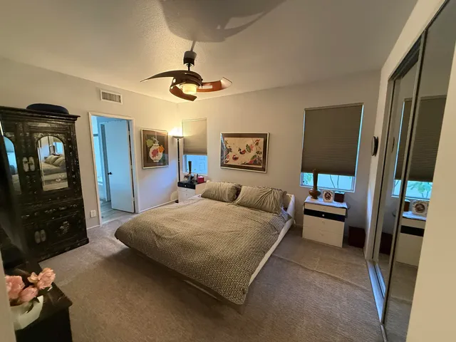 a bed sitting in a bedroom next to a window